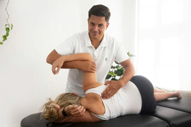 a woman getting a back massage from a man Chiropractor. Chiropractic practice services and packages guide for 2027